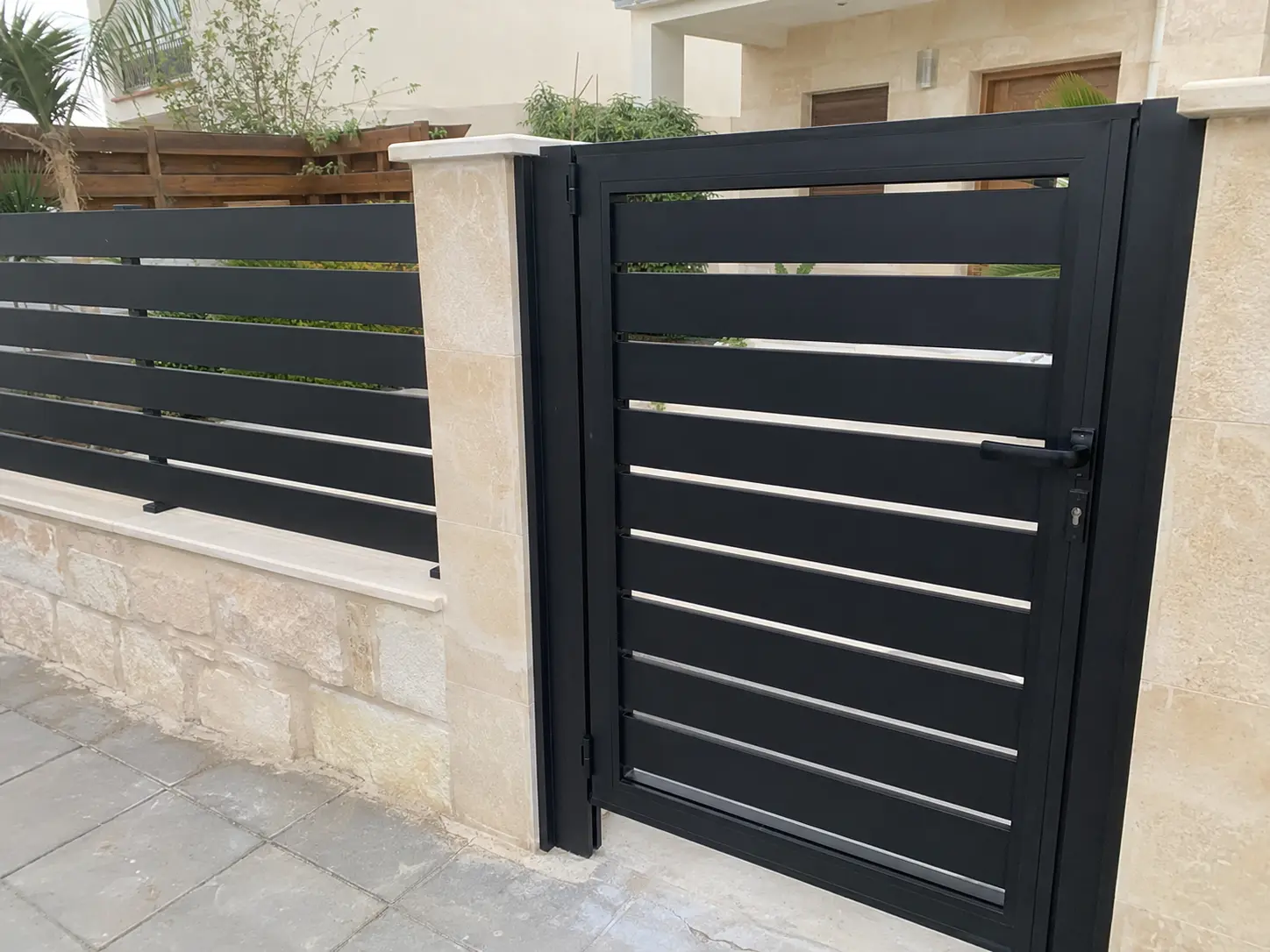 Black aluminium entrance gate and matching fence